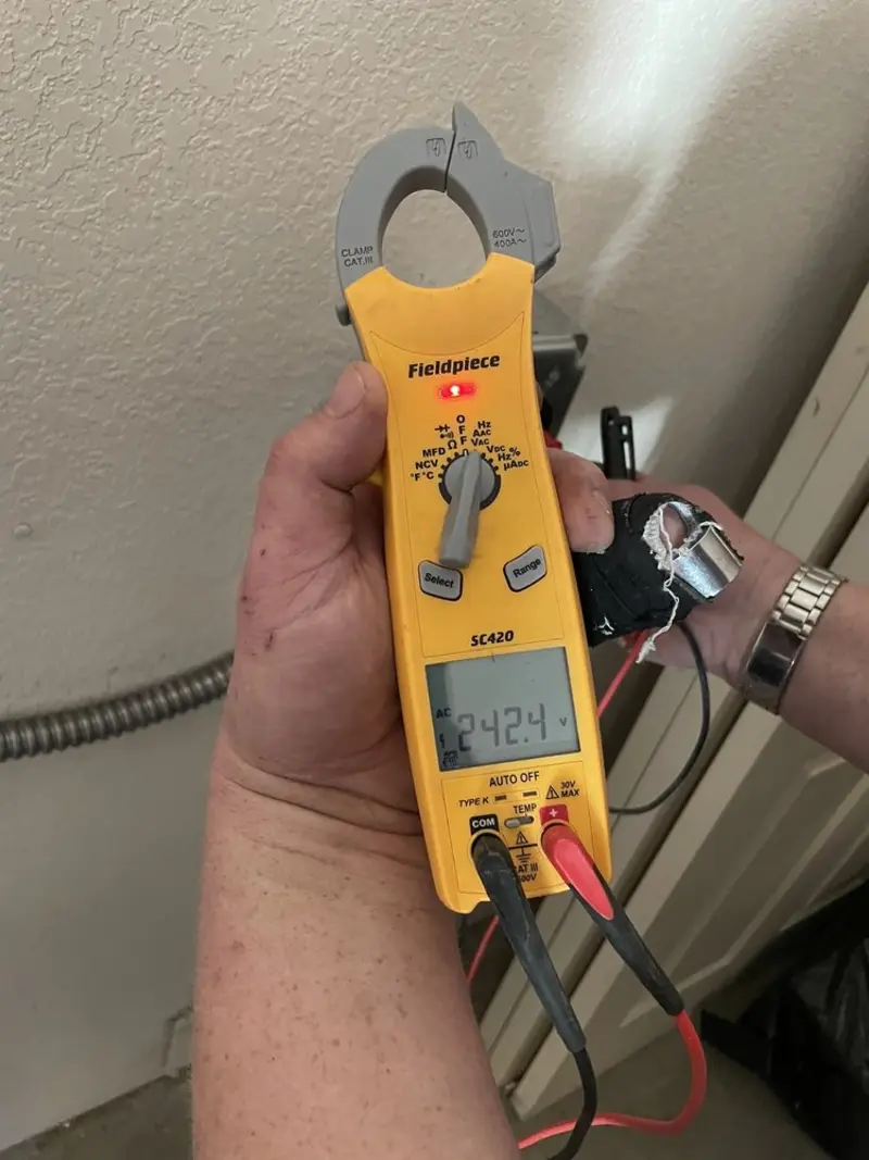 Voltage testing with clamp meter during Circuit Breaker Repair in Justin